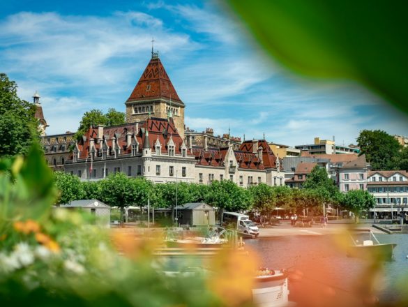 a building with a tower and a body of water in front of it