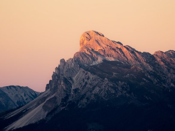 Jagged mountain peak bathed in warm sunset light.