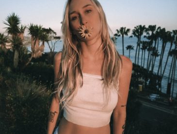 Woman with flower in mouth, palm trees, ocean view