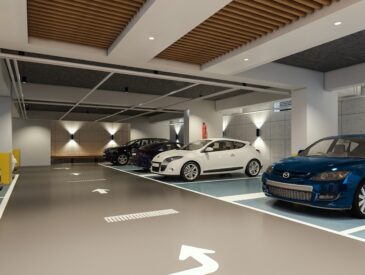 Modern indoor parking garage with parked cars.