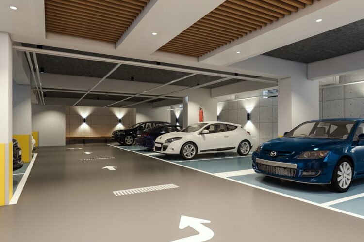 Modern indoor parking garage with parked cars.
